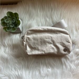 lululemon athletica Cream Crossbody Bag with textured fabric and zip closure
